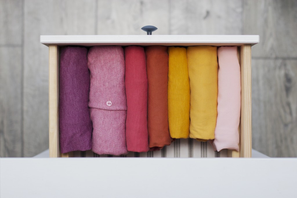 women's clothing yellow, pink and red shades neatly folded in a chest of drawers